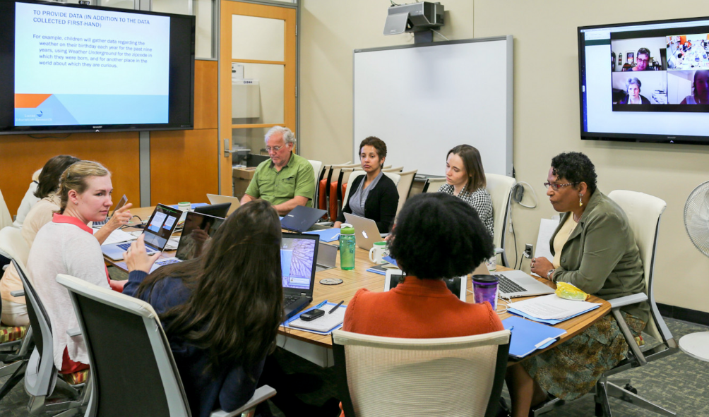 Multiple Literacies research team around a meeting table in CREATE