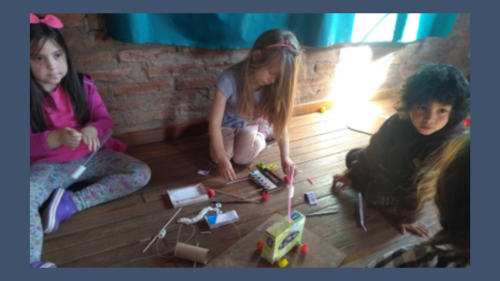 Children on floor building a toy
