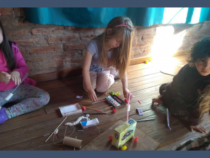 Children on floor building a toy